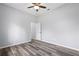Bedroom featuring wood floors, a ceiling fan, and neutral wall color at 17032 Winners Cir, Odessa, FL 33556