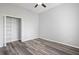 Simple bedroom with laminate floors, an open closet, a ceiling fan and neutral paint at 17032 Winners Cir, Odessa, FL 33556