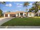 Beautiful one-story home boasts a well-manicured lawn, palm trees and a two car garage at 17032 Winners Cir, Odessa, FL 33556