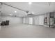 Spacious garage with gray epoxy flooring, storage area, and a refrigerator at 17032 Winners Cir, Odessa, FL 33556