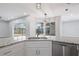 Modern kitchen featuring granite countertops, stainless steel appliances, and bright natural light at 17032 Winners Cir, Odessa, FL 33556