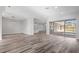 Open floor plan featuring laminate floors, recessed lighting, large windows, and access to the backyard at 17032 Winners Cir, Odessa, FL 33556