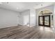 Spacious living room area with laminate floors, tall ceilings, and lots of natural light at 17032 Winners Cir, Odessa, FL 33556