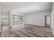 Bright and airy living room featuring laminate floors, recessed lighting, and sliding glass doors at 17032 Winners Cir, Odessa, FL 33556