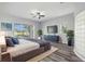 Spacious main bedroom with wood floor, sliding glass doors to pool, and accent glass block wall at 17032 Winners Cir, Odessa, FL 33556