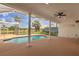 Covered outdoor pool area with screened enclosure and beautiful views of the surrounding landscape at 17032 Winners Cir, Odessa, FL 33556