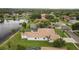 Beautiful home with well-maintained lawn, screened-in pool, and lake view at 17032 Winners Cir, Odessa, FL 33556