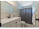 Bathroom features modern vanity, hexagon tile floor, and a shower with blue patterned shower curtain at 2257 World Parkway W Blvd # 61, Clearwater, FL 33763