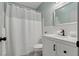 Modern bathroom features vanity with a white shower curtain, hexagon tile floor, and silver-trimmed mirror at 2257 World Parkway W Blvd # 61, Clearwater, FL 33763