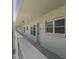 Exterior balcony view of unit with white railing, white walls and a view of the neighborhood at 2257 World Parkway W Blvd # 61, Clearwater, FL 33763