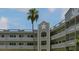 Exterior daytime shot of the condo building showing balconies and tropical landscaping at 2257 World Parkway W Blvd # 61, Clearwater, FL 33763