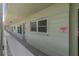 This hallway features a warning sign, painted walls, and a white railing at 2257 World Parkway W Blvd # 61, Clearwater, FL 33763