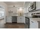 Updated kitchen boasts white cabinets, stainless steel appliances, and wood floors at 2257 World Parkway W Blvd # 61, Clearwater, FL 33763
