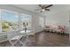 Living area with large windows, wood floors, ceiling fan, and seating at 2257 World Parkway W Blvd # 61, Clearwater, FL 33763