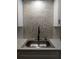 Modern kitchen sink with a stylish tiled backsplash, and elegant faucet, a sleek, functional space at 2257 World Parkway W Blvd # 61, Clearwater, FL 33763