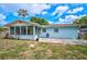 Cozy light-blue home featuring a beautiful backyard and screened-in porch with lots of windows at 2813 21St W Ave, Bradenton, FL 34205