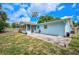 Cozy light-blue home featuring a beautiful backyard, a screened-in porch, and ample space at 2813 21St W Ave, Bradenton, FL 34205