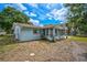 Cozy light-blue home featuring a beautiful backyard, a screened-in porch, and ample space at 2813 21St W Ave, Bradenton, FL 34205