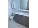 Modern bathroom featuring a marble vanity top, gray cabinetry, and decorative tiled backsplash at 2813 21St W Ave, Bradenton, FL 34205
