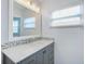 Stylish bathroom features a large mirror and vanity with gray cabinets and a marble top at 2813 21St W Ave, Bradenton, FL 34205