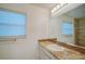 Bathroom with granite countertops, modern mirror, and mosaic tile backsplash at 2813 21St W Ave, Bradenton, FL 34205