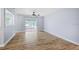 Open living room featuring wood-look floors, ceiling fan and sliding glass doors at 2813 21St W Ave, Bradenton, FL 34205