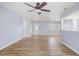 Living room with wood-look flooring, ceiling fan, and ample natural light at 2813 21St W Ave, Bradenton, FL 34205