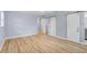 Spacious main bedroom featuring laminate flooring, light blue walls, and sliding barn door closets at 2813 21St W Ave, Bradenton, FL 34205