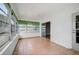 Bright sunroom featuring tiled floors, multiple windows, and a ceiling fan at 2813 21St W Ave, Bradenton, FL 34205