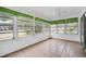 Bright sunroom featuring tiled floors, multiple windows, and a ceiling fan at 2813 21St W Ave, Bradenton, FL 34205