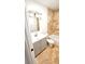 Well-lit bathroom featuring travertine tile, vanity and a tub, creating a spa-like experience at 530 74Th N Ave, St Petersburg, FL 33702