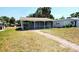 Charming single story home featuring a screened-in porch and welcoming brick walkway at 530 74Th N Ave, St Petersburg, FL 33702