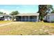 Charming home with a screened front porch, nicely landscaped yard, and mature trees, creating a welcoming curb appeal at 530 74Th N Ave, St Petersburg, FL 33702