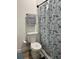 Clean bathroom featuring a toilet and a shower with a butterfly-themed curtain, creating a fresh and inviting space at 6320 Cedar St Ne, St Petersburg, FL 33702