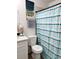 Well-maintained bathroom with a cheerful shower curtain, complementing the vanity and toilet at 6320 Cedar St Ne, St Petersburg, FL 33702