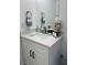 Bathroom vanity with a sleek countertop, decorative items, and a well-lit mirror, combining style and functionality at 6320 Cedar St Ne, St Petersburg, FL 33702