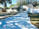 Charming single-story home featuring a freshly painted exterior, new driveway, and well-maintained landscaping at 6320 Cedar St Ne, St Petersburg, FL 33702