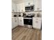 Well-equipped kitchen with stainless steel appliances, white cabinets, and a modern design, perfect for culinary enthusiasts at 6320 Cedar St Ne, St Petersburg, FL 33702