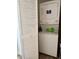 Efficient laundry area with a stacked washer and dryer unit and a louvered door for discreet storage at 6320 Cedar St Ne, St Petersburg, FL 33702