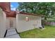 Back exterior view of the home with a fenced backyard and lush landscaping at 15609 Timberline Dr, Tampa, FL 33624