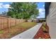 Large backyard with a new fence and ample room for outdoor activities and gardening at 15609 Timberline Dr, Tampa, FL 33624