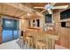 Wood-paneled room with built in bar and stools at 15609 Timberline Dr, Tampa, FL 33624
