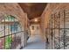 Arched brick entryway with ornate iron gate leading to double front doors at 15609 Timberline Dr, Tampa, FL 33624