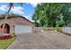 Brick home with an attached two-car garage and manicured lawn at 15609 Timberline Dr, Tampa, FL 33624