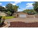 Charming single-story brick home with a well-manicured lawn and two-car garage at 15609 Timberline Dr, Tampa, FL 33624