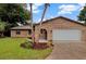 Charming brick home with well-maintained lawn and mature palm trees at 15609 Timberline Dr, Tampa, FL 33624