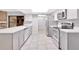 Open kitchen features white cabinetry, stainless steel appliances and tile flooring at 15609 Timberline Dr, Tampa, FL 33624