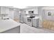 Modern kitchen with stainless steel appliances, white cabinets, and ample counter space at 15609 Timberline Dr, Tampa, FL 33624