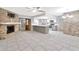 Living room with brick fireplace and kitchen with stainless steel appliances in view at 15609 Timberline Dr, Tampa, FL 33624