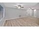 Spacious living room with modern ceiling fans and beautiful wood-look laminate flooring at 15609 Timberline Dr, Tampa, FL 33624